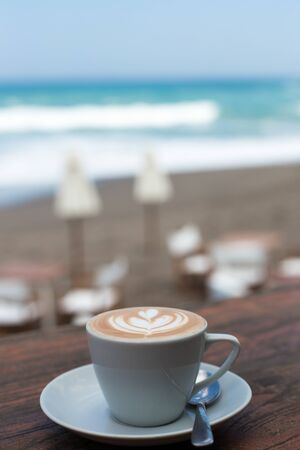 Cup of hot cappucino on wooden table background.の写真素材