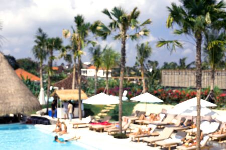 People chilling closed to swimming pool under the palms. Vacation concept.の写真素材