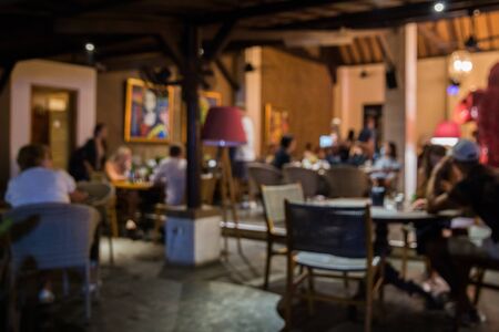 Blurred background of people in the cafe. Big long table in loft style. Top view. Team work concept.の写真素材