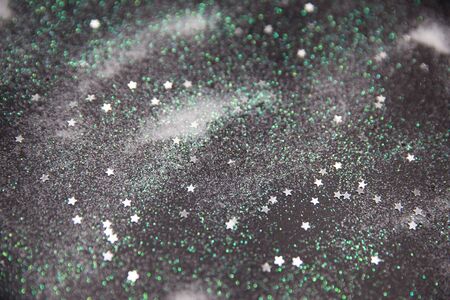 Glamour snowy white and green background with silver stars. Holiday festive concept on black backdrop.の写真素材