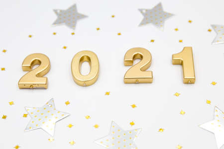Creative Christmas and New Year composition with confetti, silver stars and 2021 numbers. Flat lay.の写真素材
