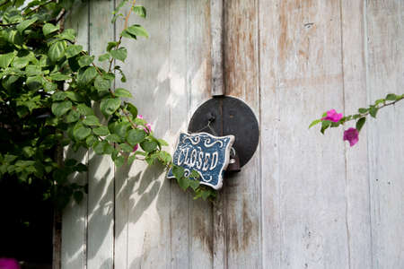 Closed board on wooden white decorative door.