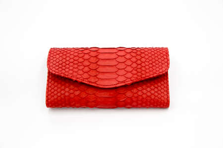Trendy natural red snake python skin woman wallet on white isolated background. Can be used for background and wallpaperの写真素材