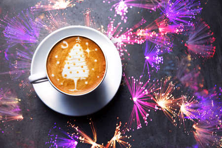 Tasty cappuccino with Christmas tree latte art on gray concrete background. Holiday concept.の写真素材