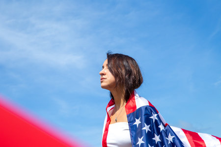 young beautiful woman holding USA flagの写真素材
