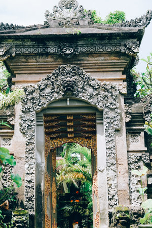 Traditional Balinese temple gate adorned with intricate carvings.の写真素材