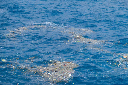 Ocean Pollution with Plastic Debris Floating on Water Surfaceの写真素材