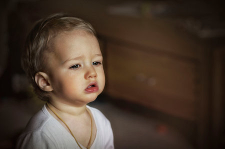 Cute baby looking out the window / Pensive Glanceの写真素材