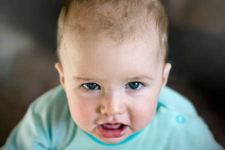 Baby face close-up, Sharp glance, Mischievous glanceの写真素材