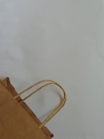 Paper shopping eco bag with handle isolated over white background.Copy spase for design.の写真素材