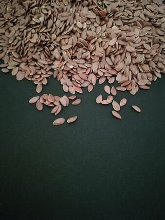 Flax seeds on black background, vintage colorの写真素材