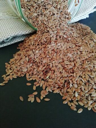 Flax seeds in the sack on black background, vintage color toneの写真素材