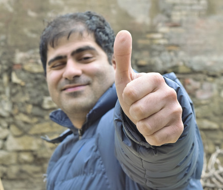 young man shows a gestureの写真素材