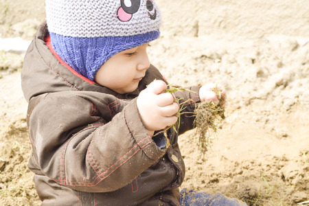 small child 1, 5 years playing in the sandの写真素材