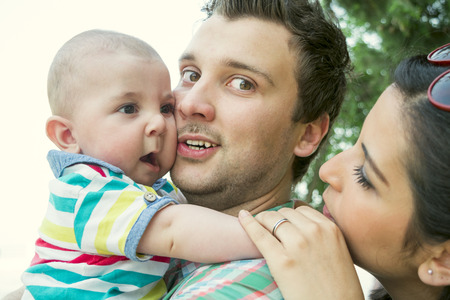 a young couple with a small child in the Parkの写真素材