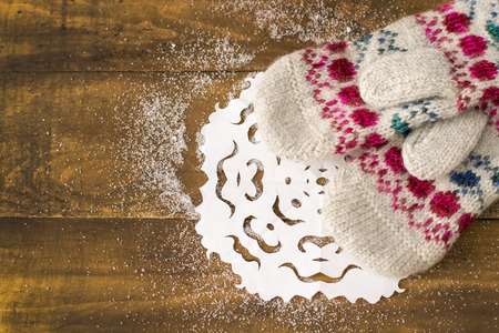 beautiful knitted mittens on a wooden backgroundの写真素材