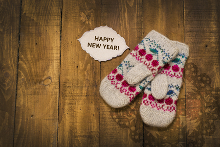 beautiful knitted mittens on a wooden backgroundの写真素材