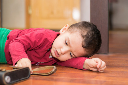 boy 2 years lying on the floor playingの写真素材
