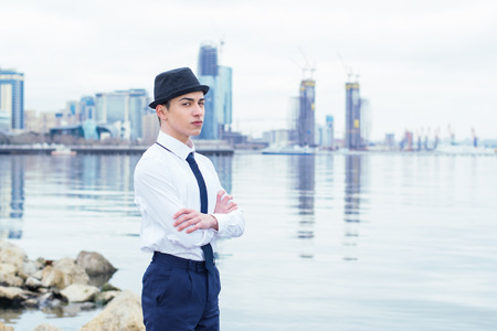 fashionable young man in a hat stands out of the seaの写真素材