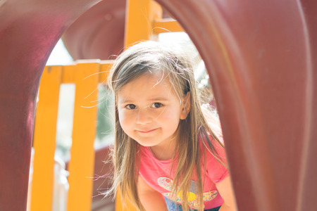 the little girl on the Playground in the summerの写真素材