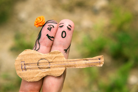 Funny men playing the guitar and singing. Relationship. Romanceの写真素材