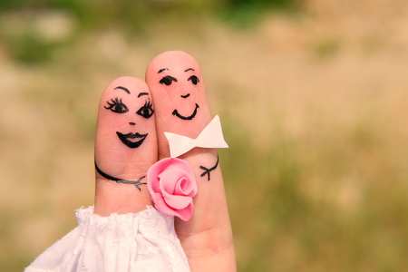 Funny men painted on the fingers. Newlyweds. Weddingの写真素材