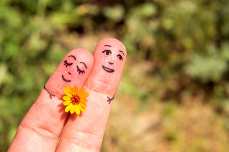 Drawn on the fingers of men with a flower. The concept of Dating. Family. Relationshipの写真素材