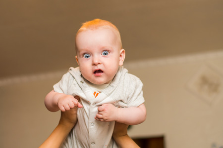 mom's hands are holding the babyの写真素材