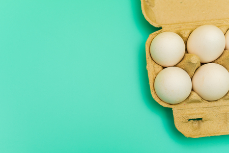 pack of chicken eggs on blue backgroundの写真素材