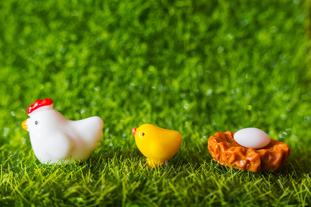 figures of chicken, chick and egg on the grass. conceptの写真素材