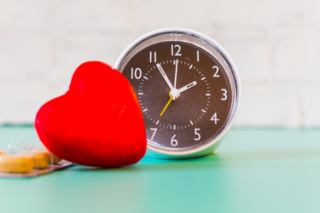 watch, pills and heart shape. the concept of caring for the heart