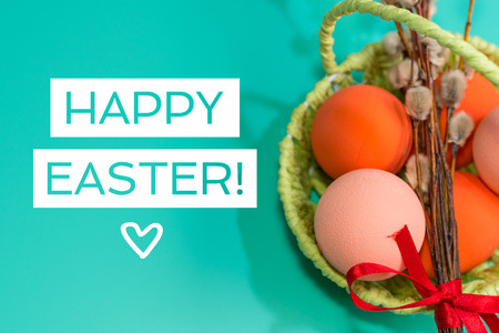 in the basket painted eggs on a turquoise background. happy Easter concept