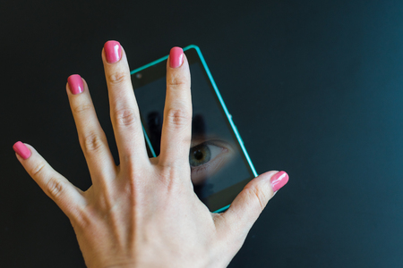 concept of peeping and eavesdropping through mobile devices.の写真素材