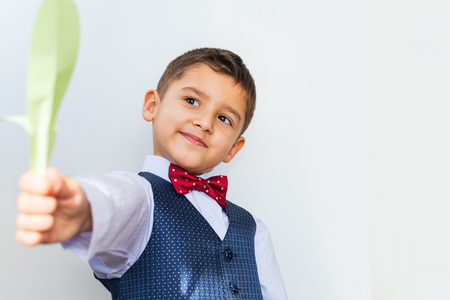 cheerful boy holding a paper flowerの写真素材