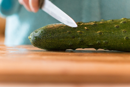 the knife and the cucumber. the concept of circumcisionの写真素材