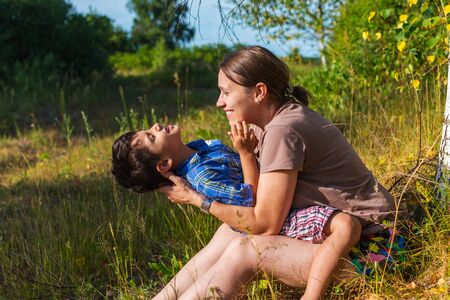mom and son have fun outdoors in summer