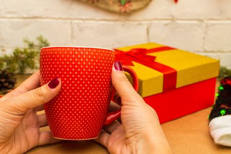 new year mood. red cup in hand on the background scenery.の写真素材