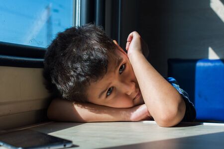 boy 6 years bored on a train tripの写真素材