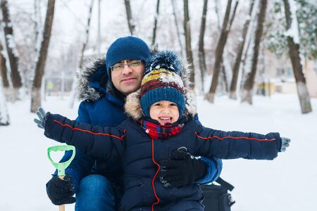 cheerful boy on a walk with dad in winter