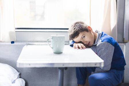 sad boy traveling on a trainの写真素材