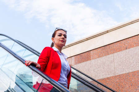 business woman goes down the escalatorの写真素材