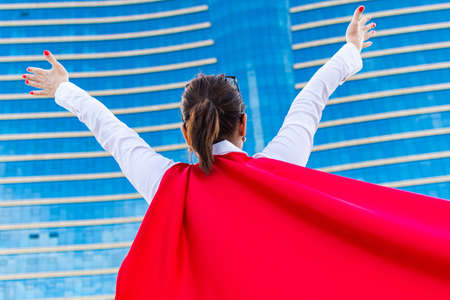business woman with a super hero cape. rear viewの写真素材