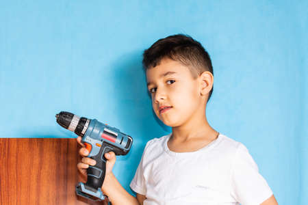 portrait of a 7 year old boy with a screwdriverの写真素材