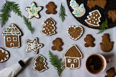 Decorating homemade cookies for Christmas, work in progress. Traditional  dessert. Holiday fun background. Top view. Flat layの写真素材