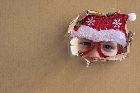 Little Santa. Surprise. Holiday background. Christmas is here. Think outside the boxの写真素材