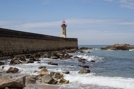 View from Carneiro beach in Porto to pier and lighthouse Felgueiras. Visit Portugal and travel concept.の写真素材