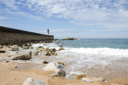 View from Carneiro beach in Porto to pier and lighthouse Felgueiras. Visit Portugal and travel concept.の写真素材