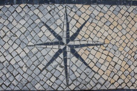 Street mosaic, stone pavement with wind rose background. Sidewalk art.の写真素材