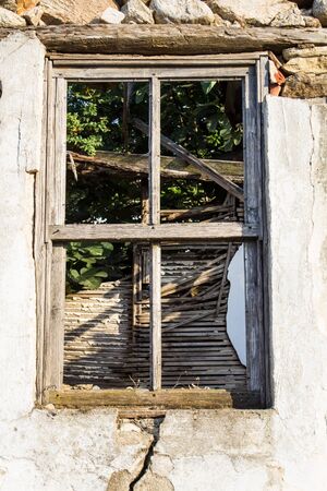 Broken window on old abandoned house. Close upの写真素材