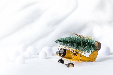Christmas tree on retro airplane toy. Happy holidays concept. Copy space